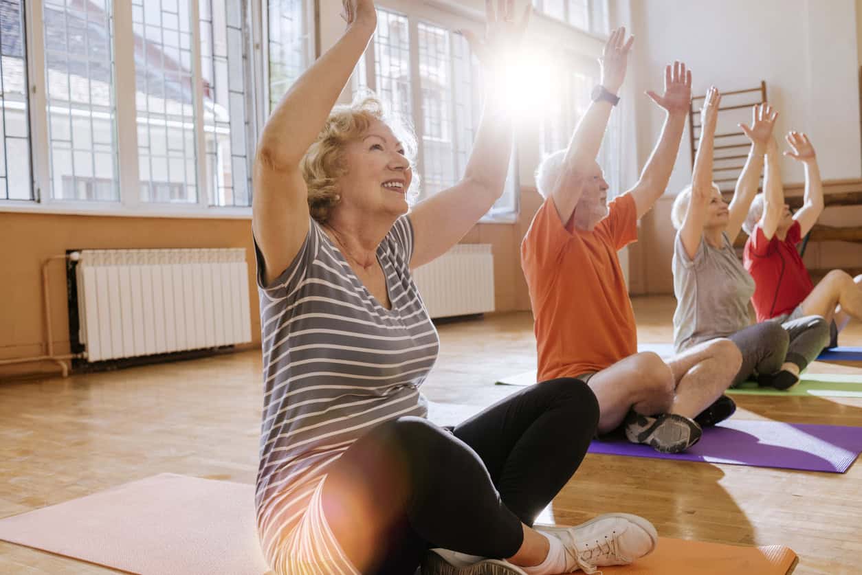 group of seniors beginning a yoga class