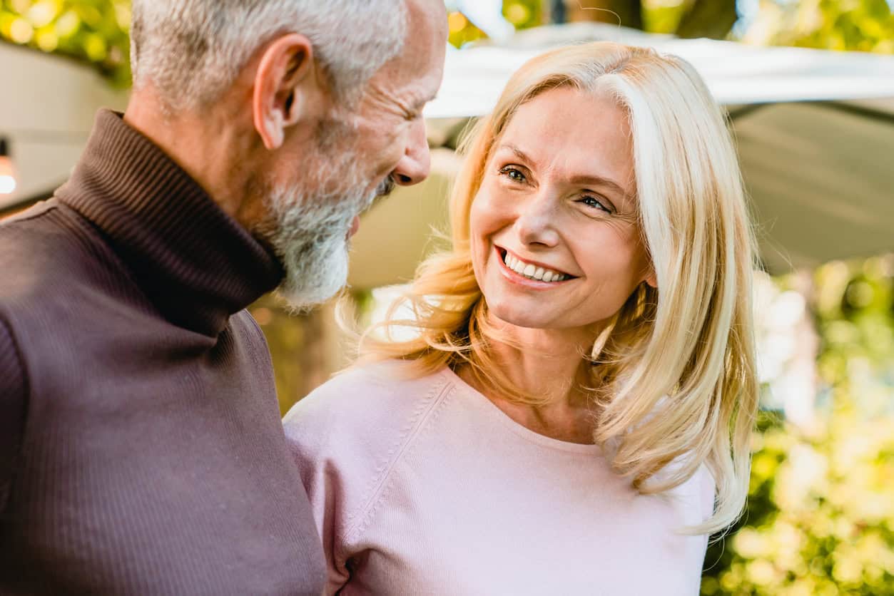 Cheerful couple in their 60's looking at each other with passion and love