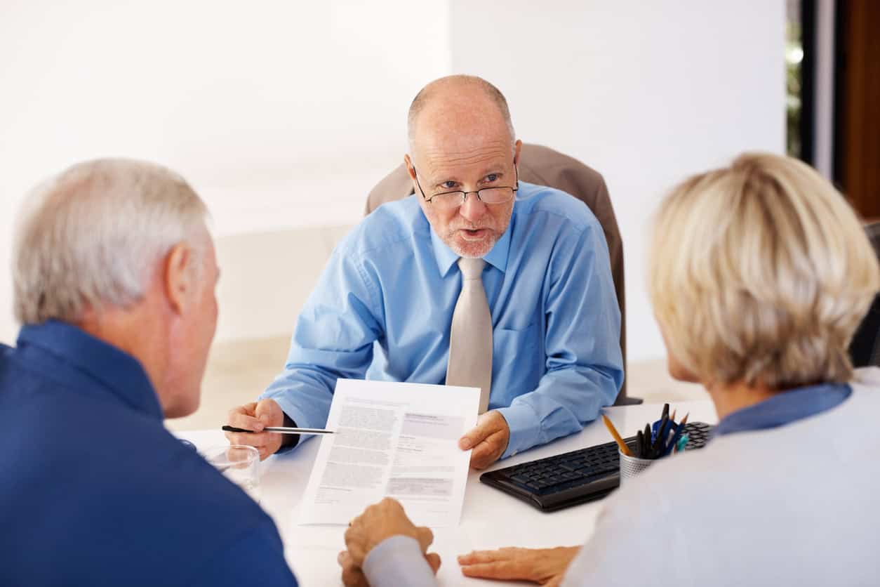 elderly couple reviewing end-of-life financial planning with advisor